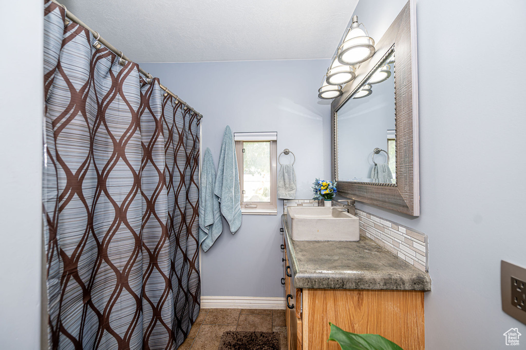 Full bathroom featuring vanity, a shower with shower curtain, and a chandelier