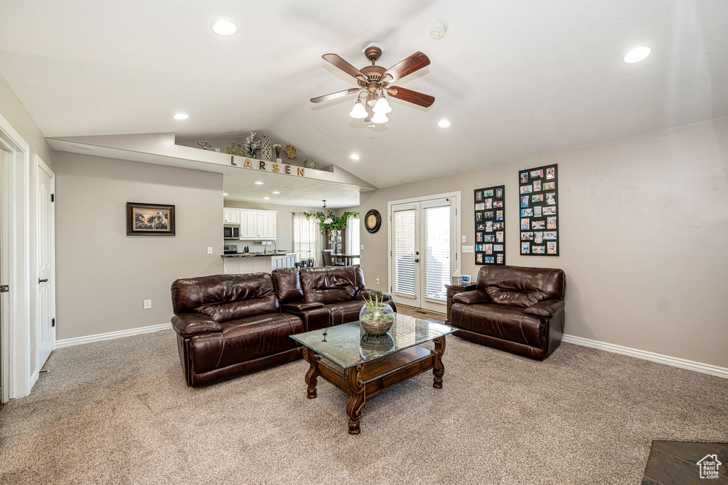 Living area featuring light colored carpet, ceiling fan, recessed lighting, vaulted ceiling, and french doors