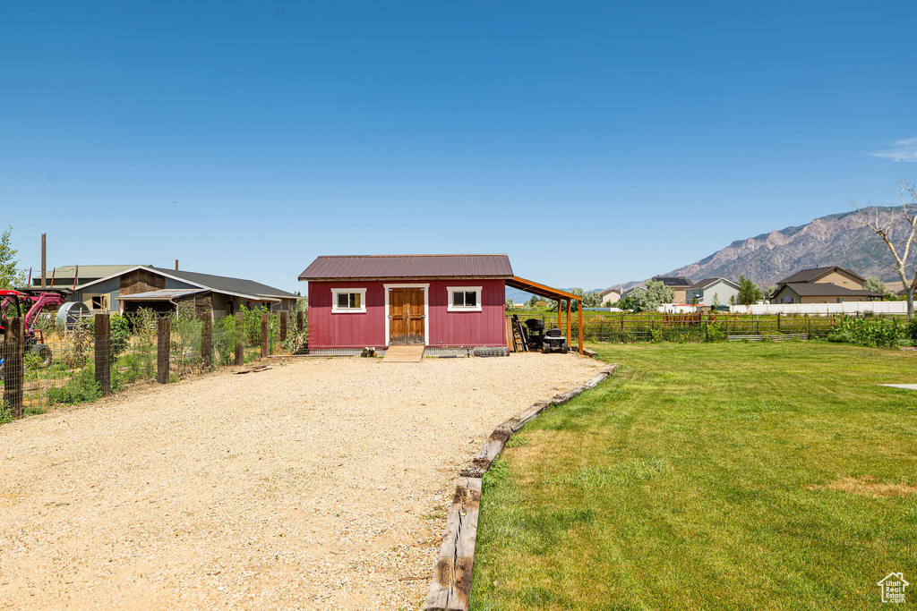 Rear view of house featuring an outdoor structure and a mountain view