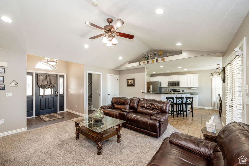 Living area featuring recessed lighting, lofted ceiling, ceiling fan, healthy amount of natural light, and light tile patterned floors