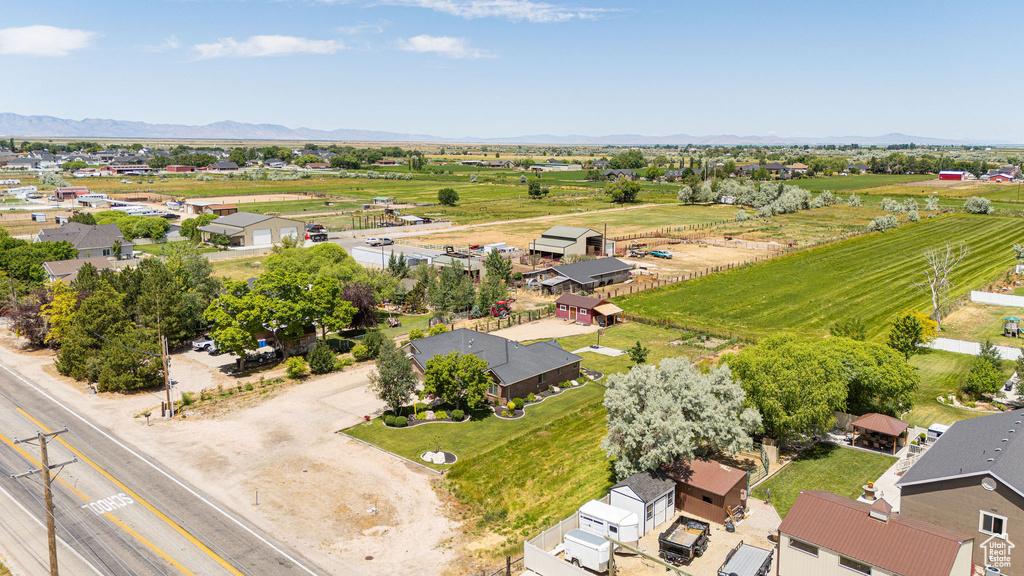 Overview of rural landscape featuring a mountain backdrop and nearby suburban area