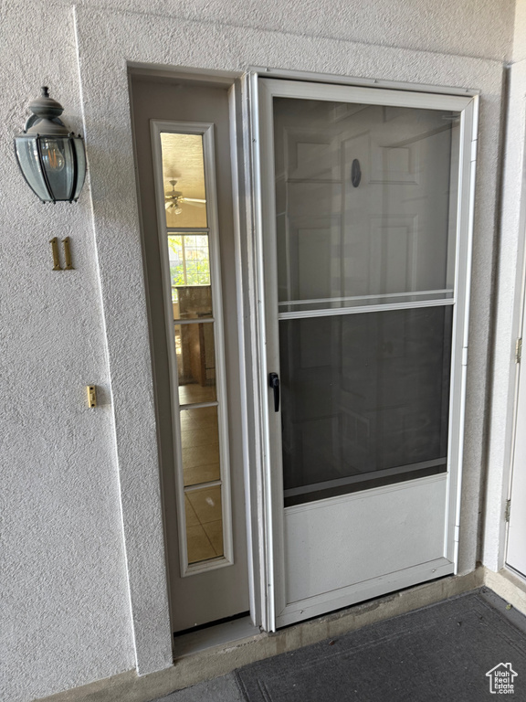 Entrance to property with stucco siding