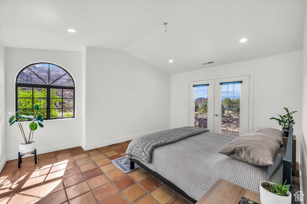 Tiled bedroom with access to outside, lofted ceiling, french doors, and recessed lighting