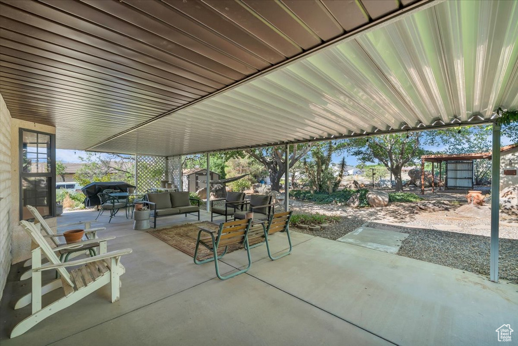 View of patio featuring a storage shed, outdoor lounge area, and area for grilling
