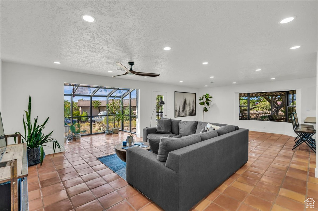 Tiled living area featuring recessed lighting, plenty of natural light, and a ceiling fan