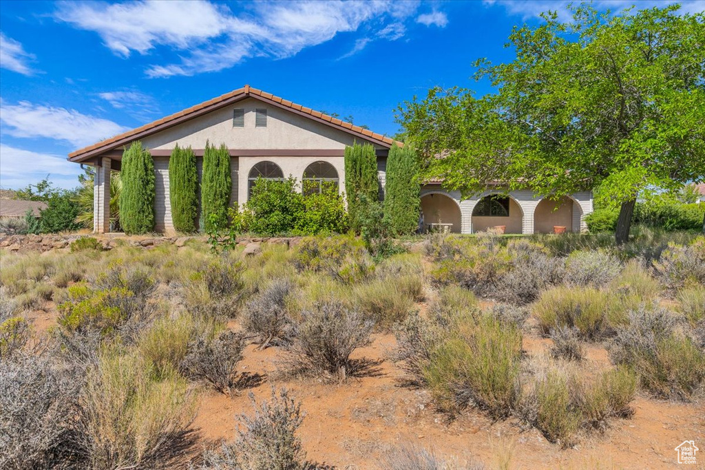 View of front of property featuring stucco siding and a tiled roof
