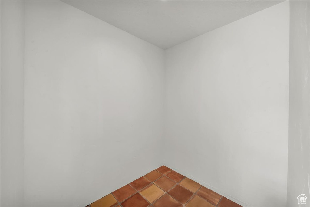 Unfurnished room with dark tile patterned flooring