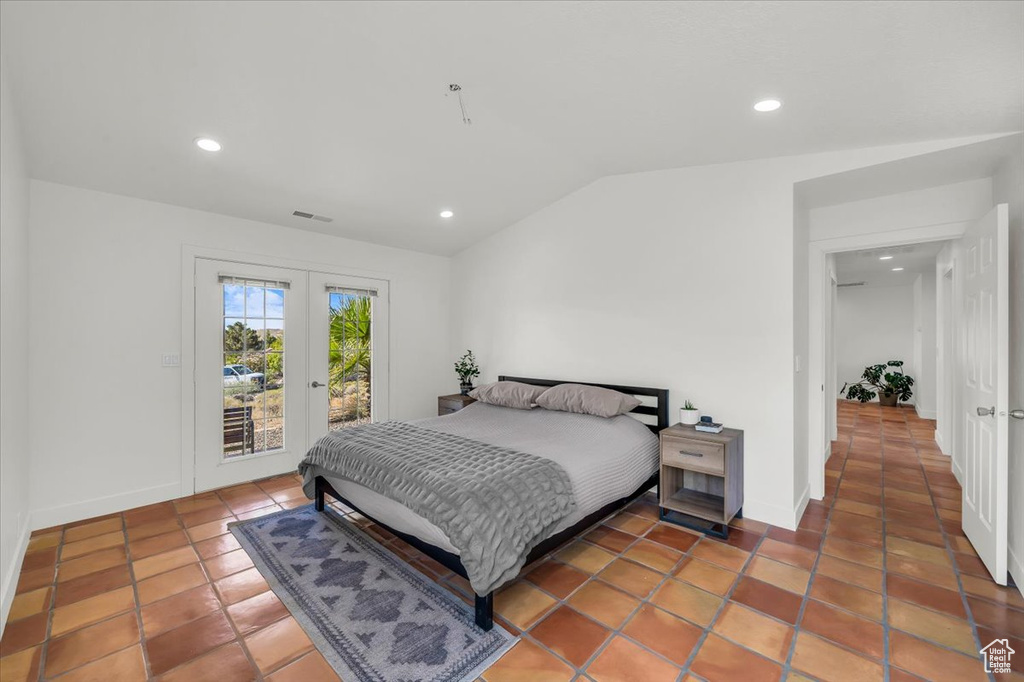 Tiled bedroom featuring access to exterior, lofted ceiling, french doors, and recessed lighting