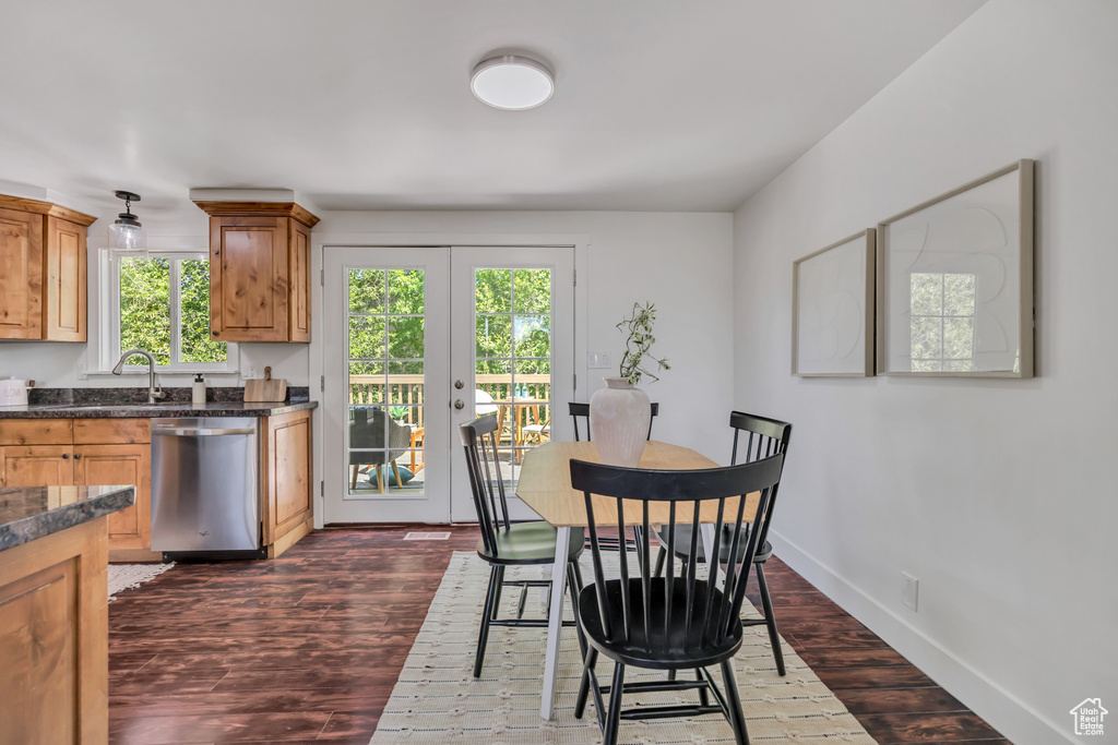 Dining room with dark wood-style flooring and french doors