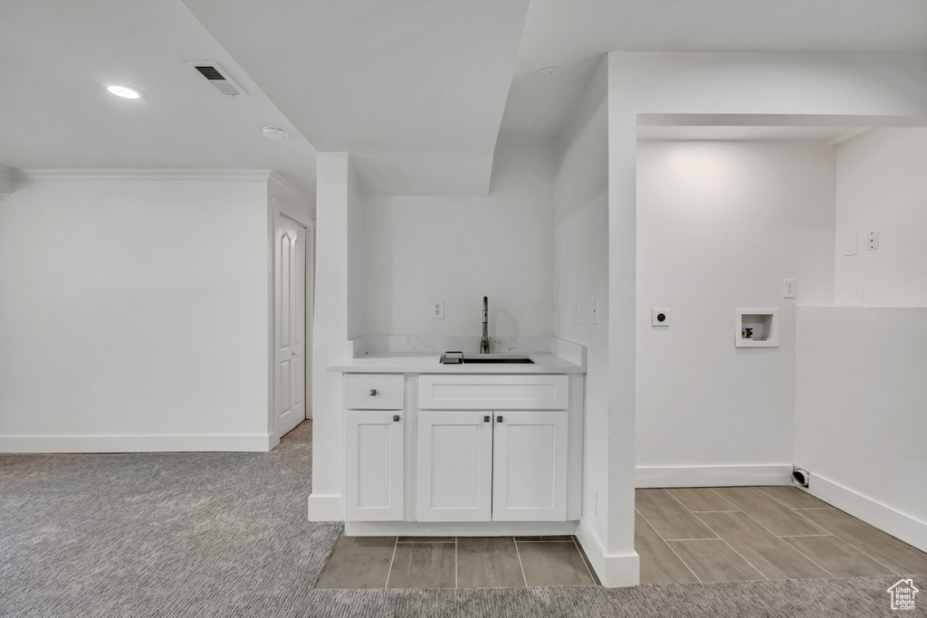Laundry room with electric dryer hookup, washer hookup, and recessed lighting