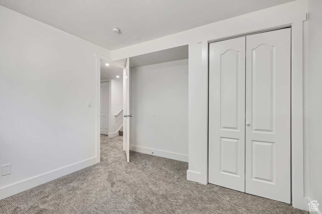 Unfurnished bedroom with carpet floors, a closet, and recessed lighting