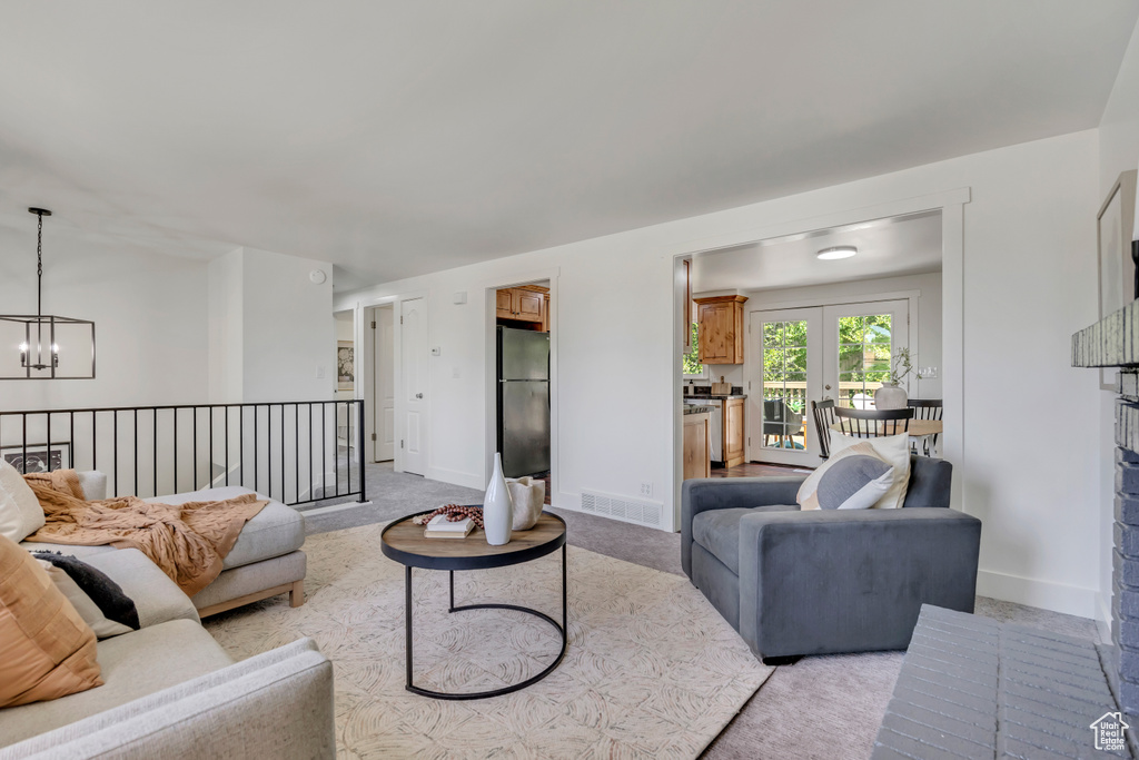 Living room featuring a chandelier and light colored carpet