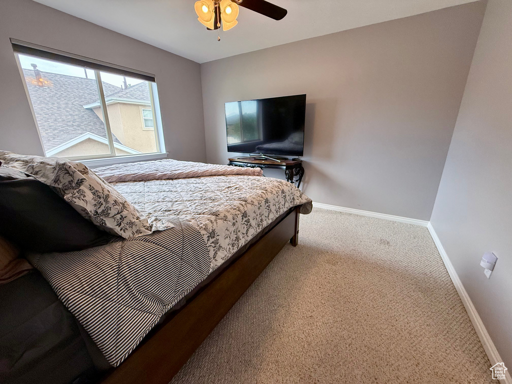 Bedroom with carpet floors and a ceiling fan