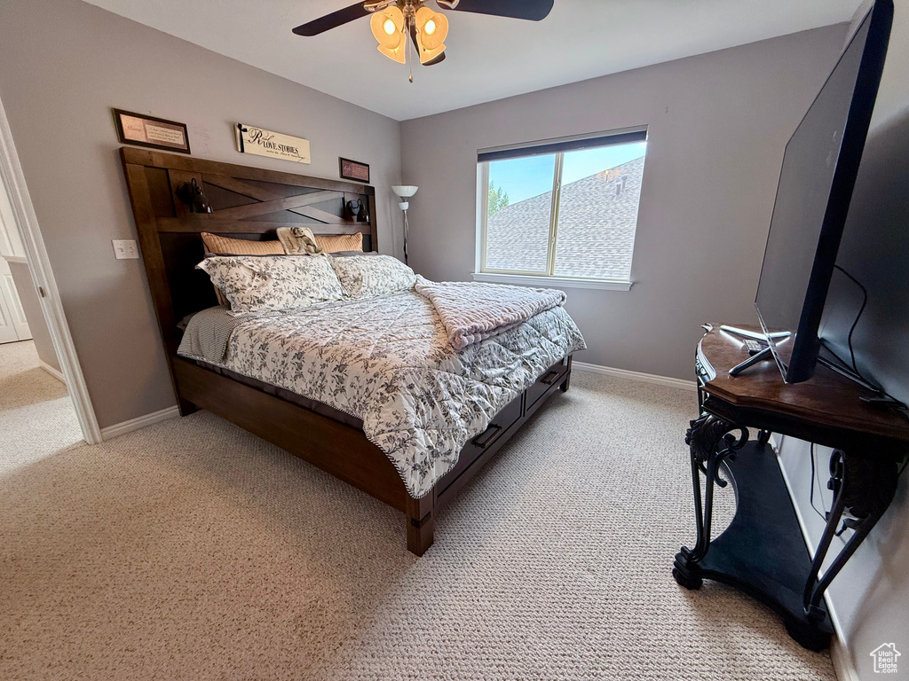 Bedroom featuring light carpet and a ceiling fan