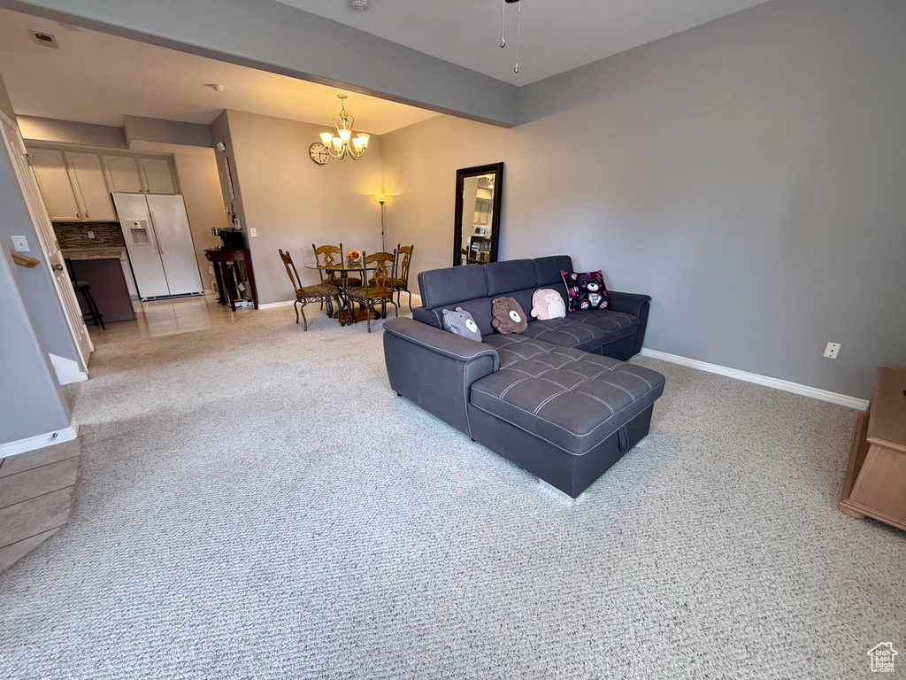 Living room featuring a chandelier and light colored carpet