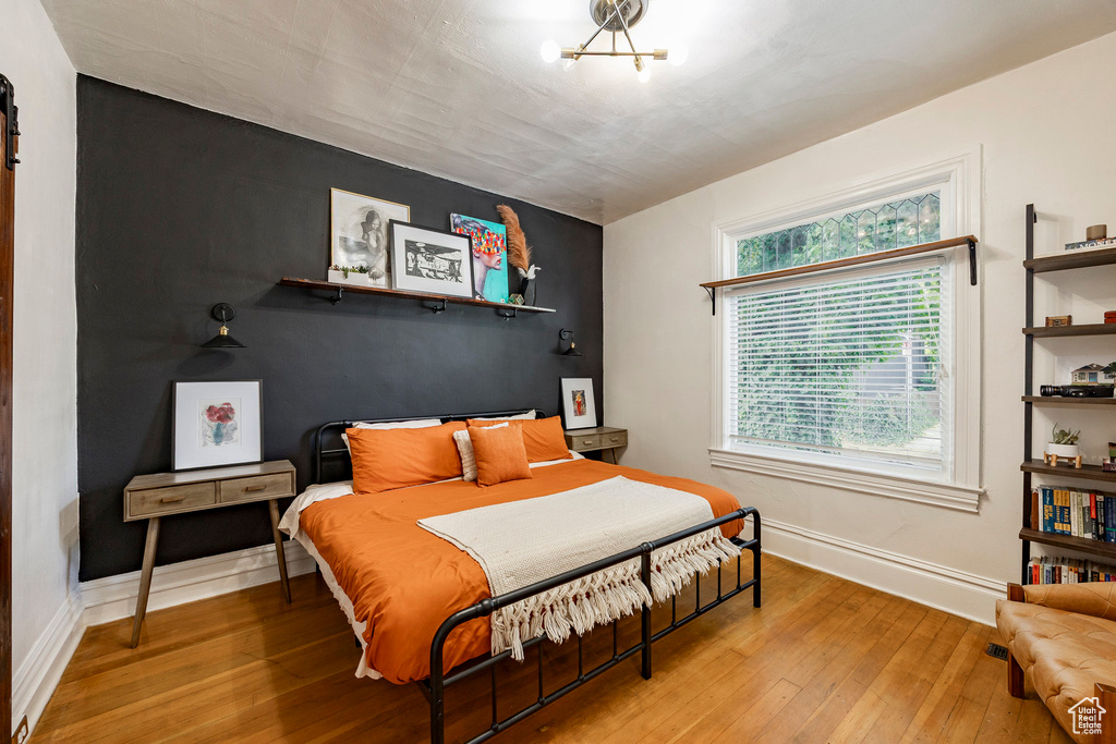Bedroom with light wood finished floors and baseboards