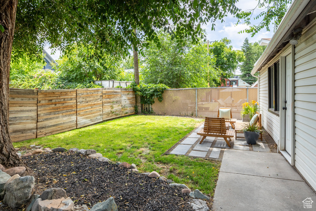 Fenced backyard with a patio