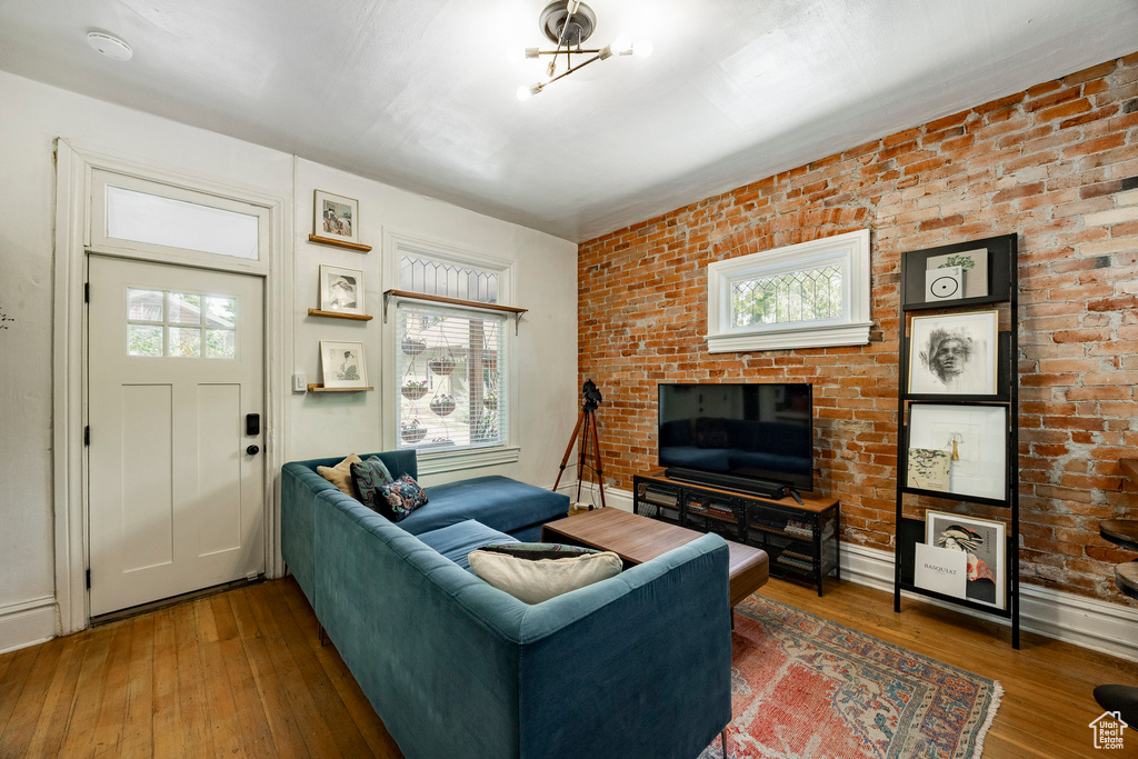 Living area with healthy amount of natural light and wood-type flooring