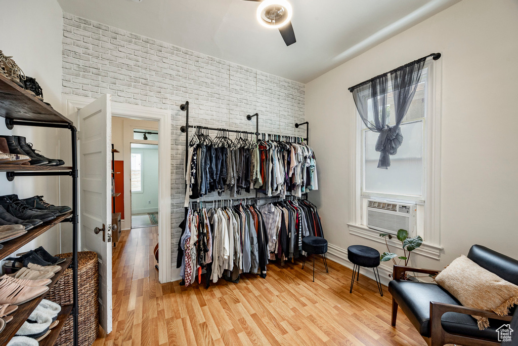 Spacious closet featuring wood finished floors and cooling unit