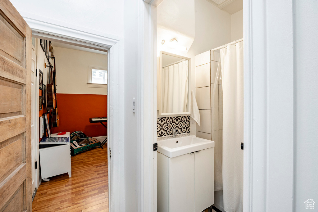 Laundry room featuring light wood-type flooring and a sink
