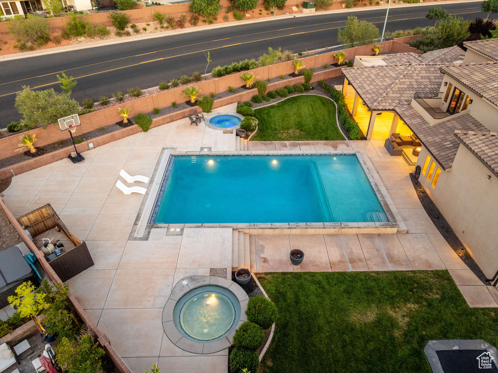 View of pool with an in-ground hot tub and a patio area