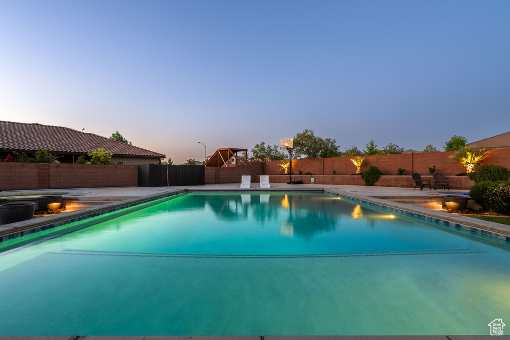 View of swimming pool with a fenced backyard and a patio area