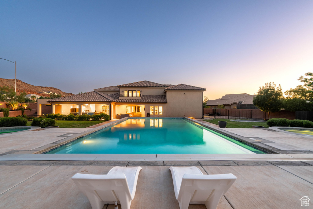 Pool at dusk with a patio