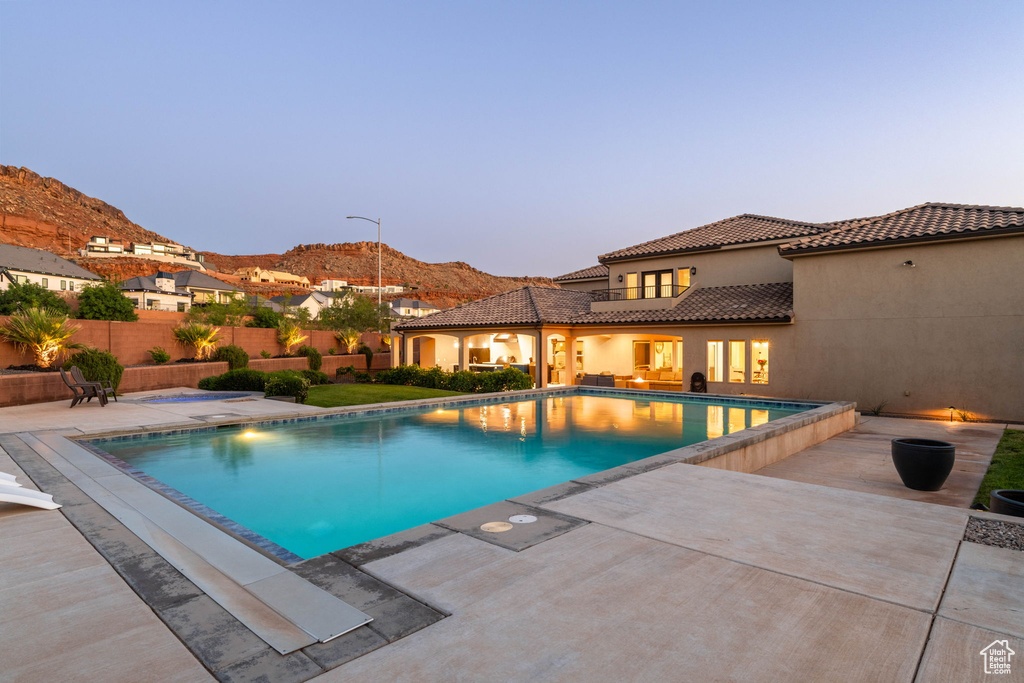 View of pool with a patio area and a mountain view