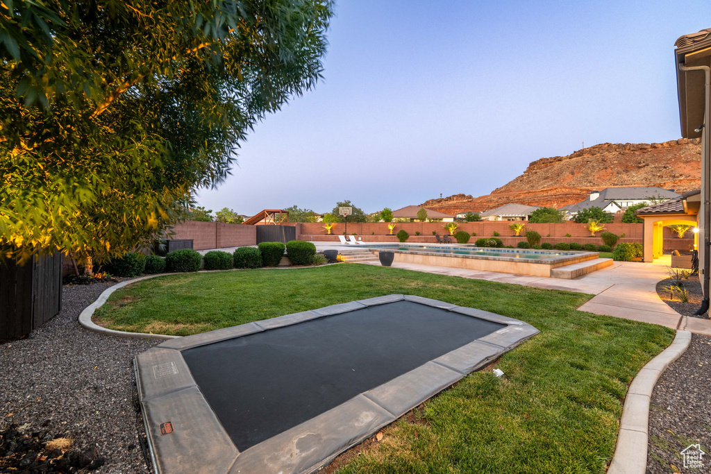 Fenced backyard with a mountain view and a patio