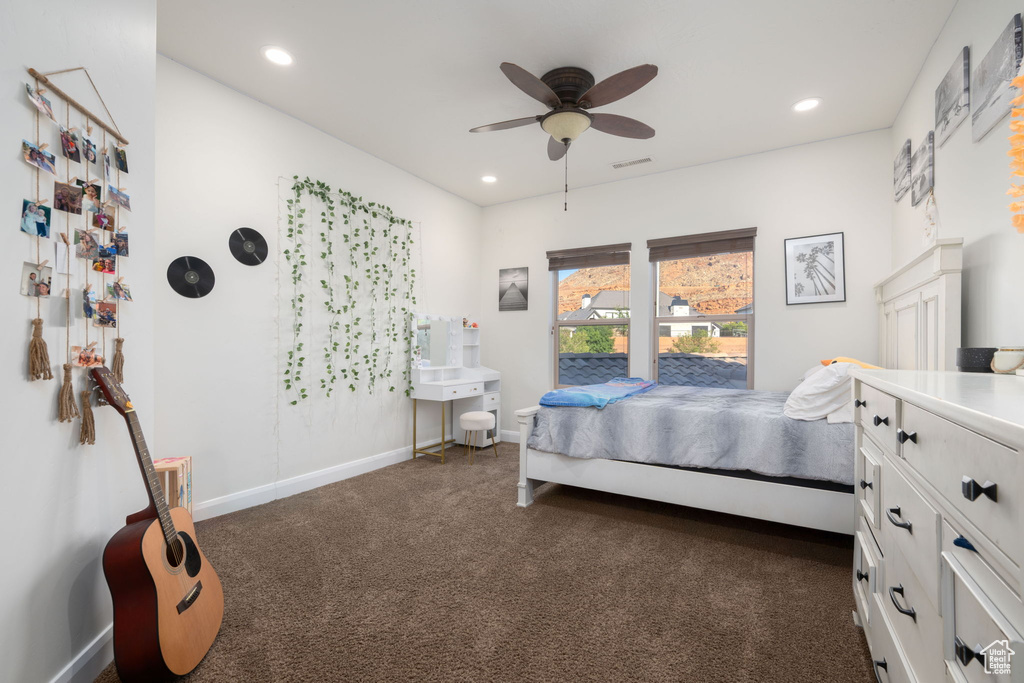 Bedroom with dark colored carpet, recessed lighting, and ceiling fan