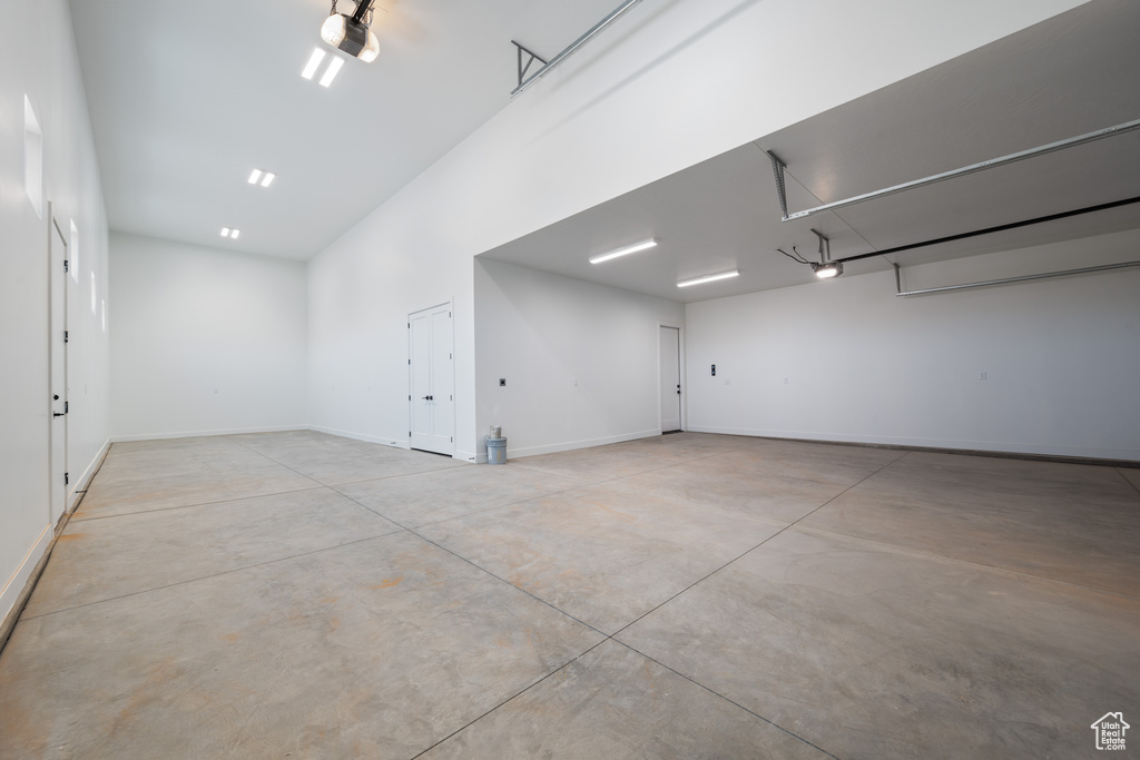 Garage with a garage door opener and baseboards