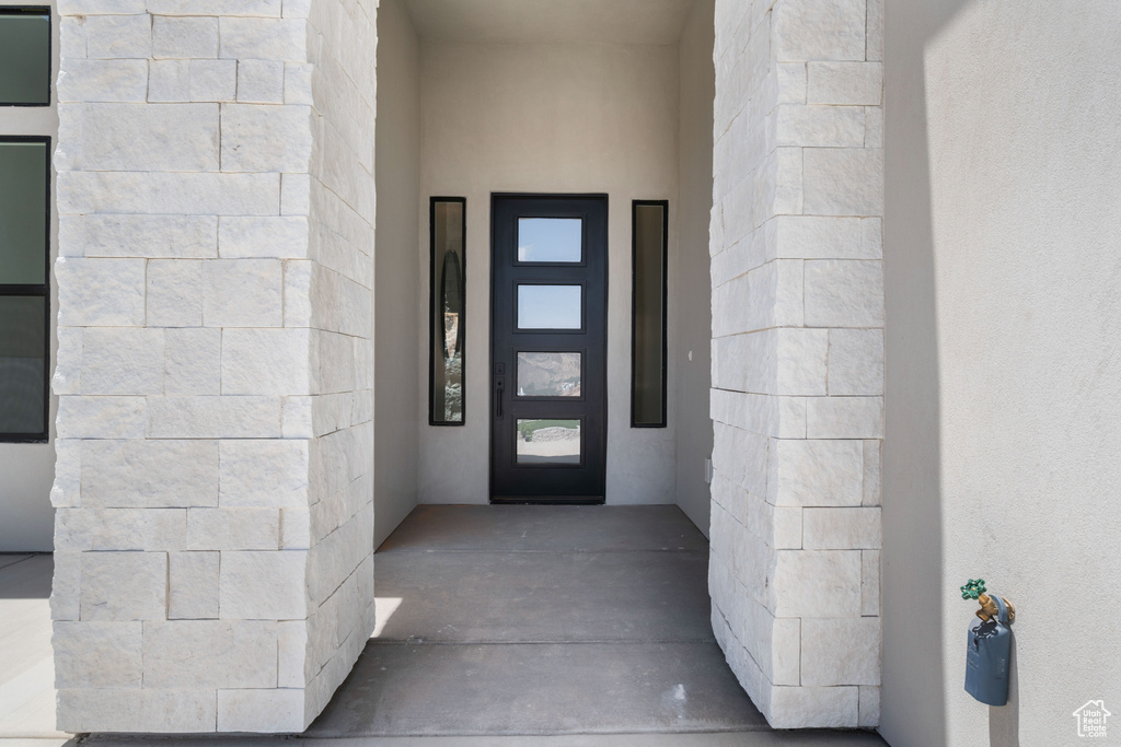 View of exterior entry with stucco siding