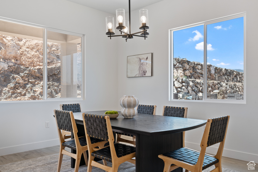 Dining space featuring a chandelier and wood finished floors