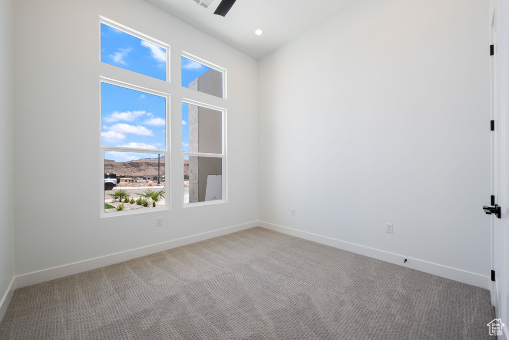 Spare room with light colored carpet, a mountain view, a ceiling fan, and recessed lighting
