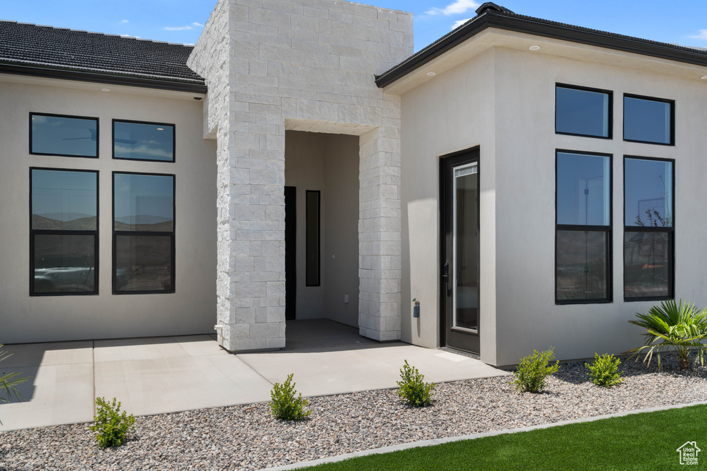 Back of property featuring a patio and stucco siding