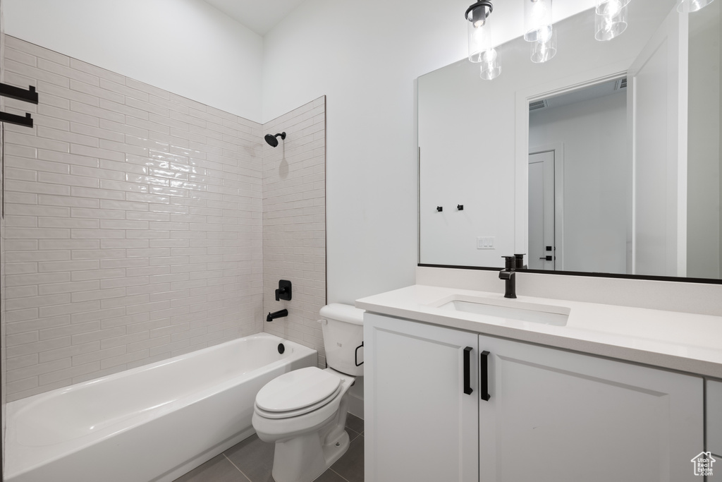 Bathroom featuring vanity, shower / washtub combination, and tile patterned floors