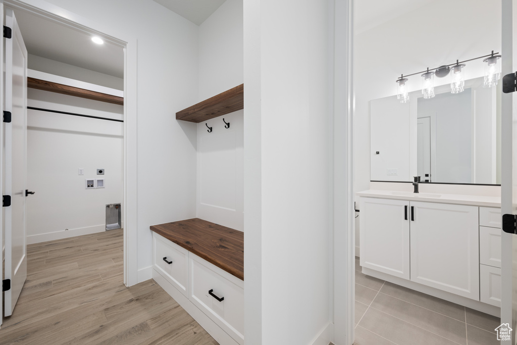 Mudroom with a sink and light wood-type flooring