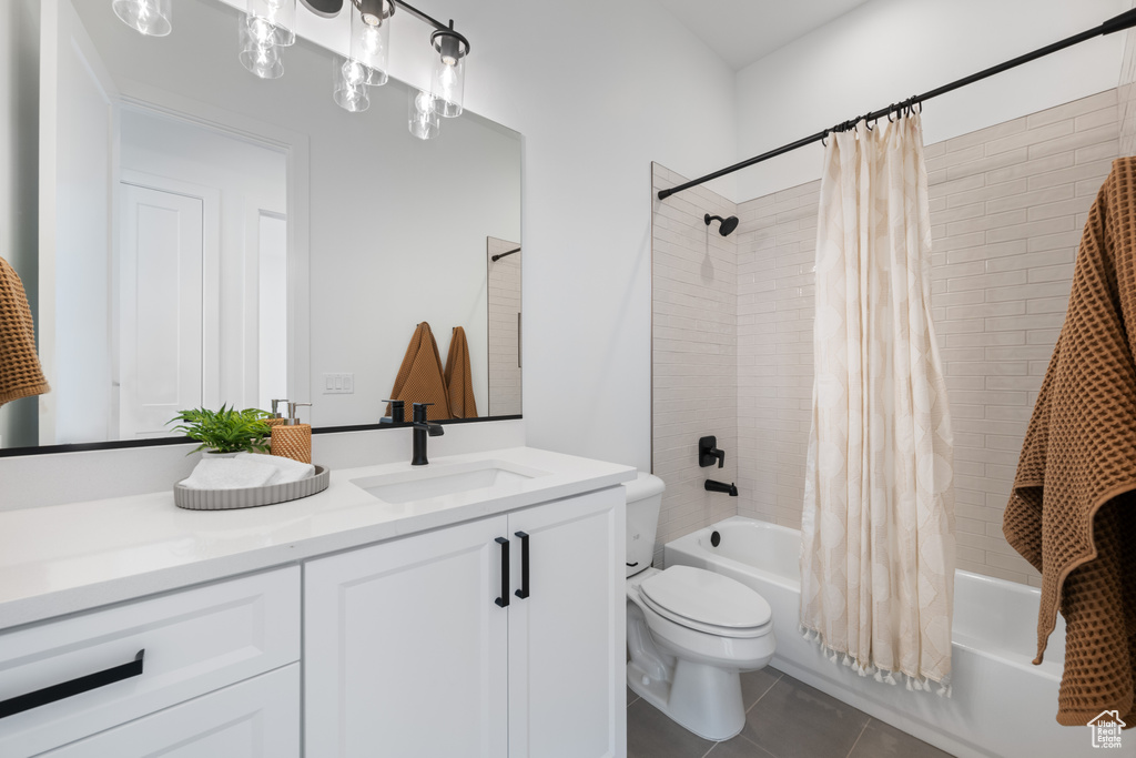 Bathroom with vanity, shower / bath combination with curtain, and tile patterned floors