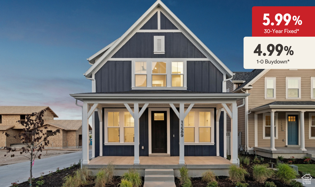 View of front of property featuring board and batten siding and covered porch