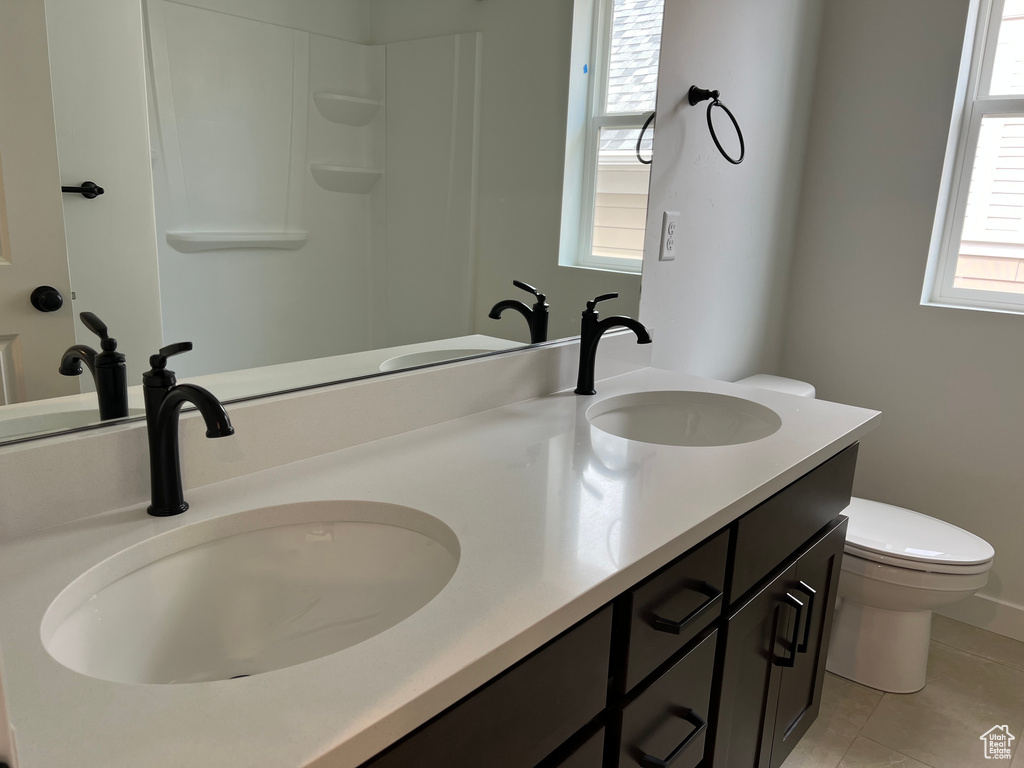 Bathroom featuring double vanity and tile patterned floors