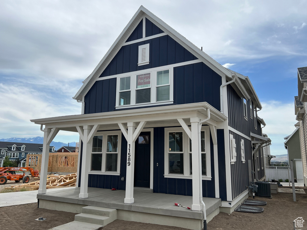 View of front of house featuring covered porch and board and batten siding