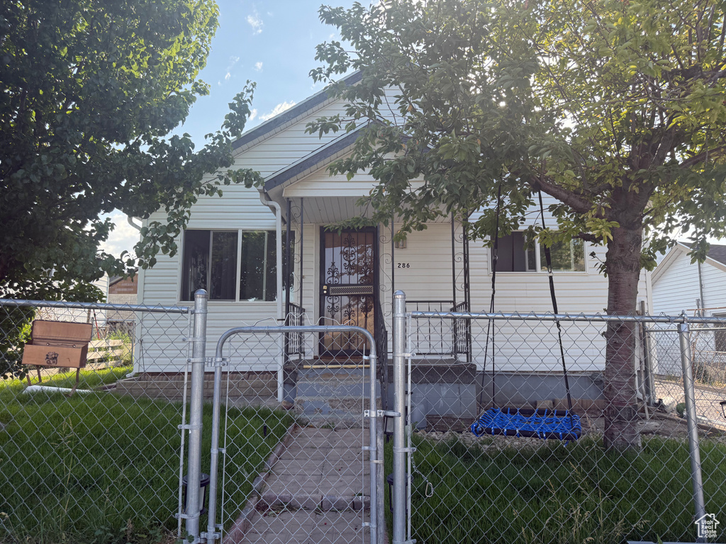 View of front of home with a gate and a fenced front yard