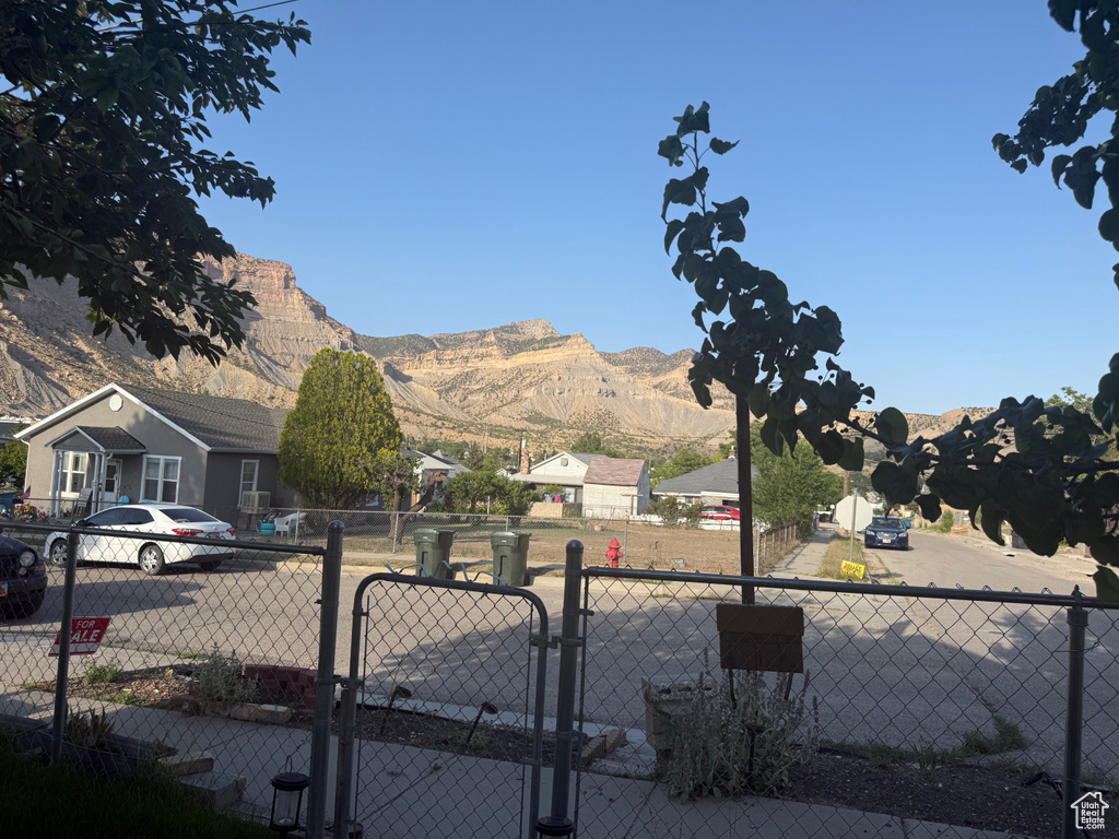 View of yard featuring a mountain view and a gate
