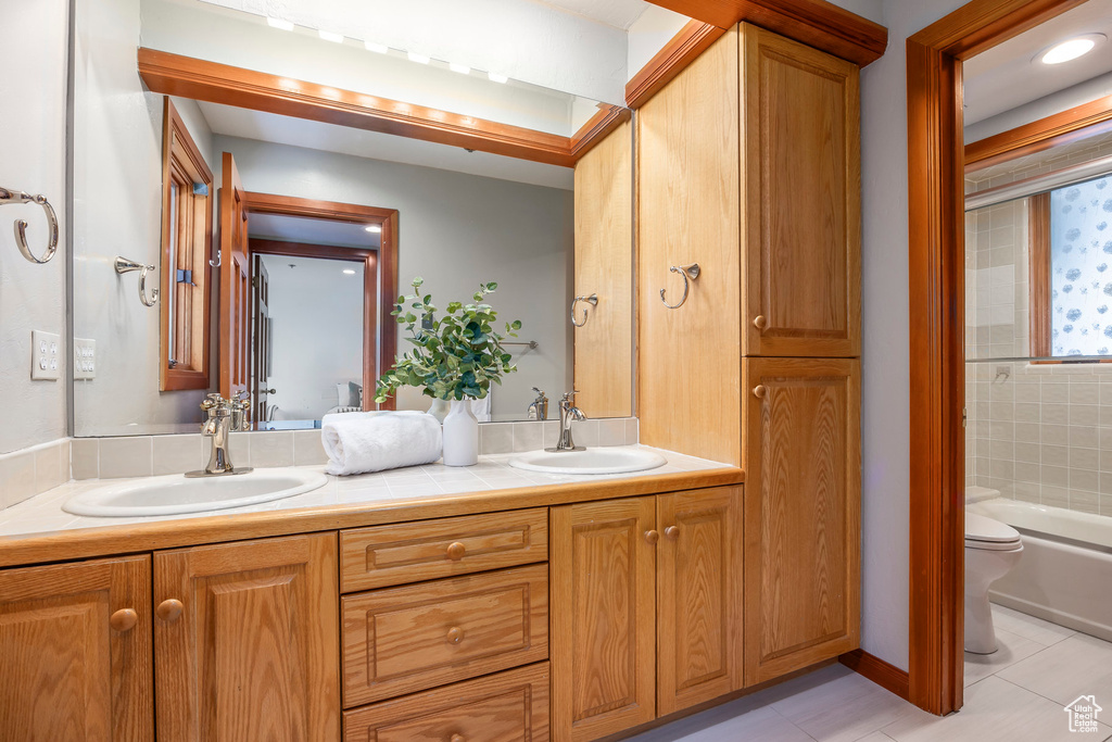 Full bathroom featuring double vanity and tile patterned floors