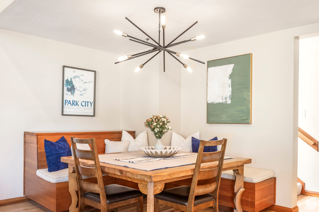 Dining room featuring breakfast area, a chandelier, and light wood-style floors