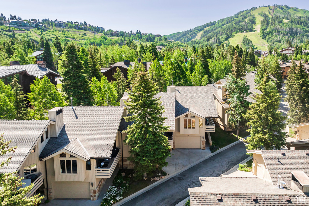Aerial view of property and surrounding area with a mountainous background