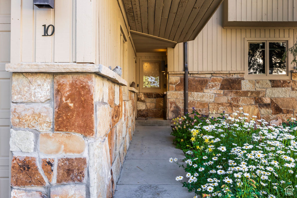 Doorway to property with stone siding