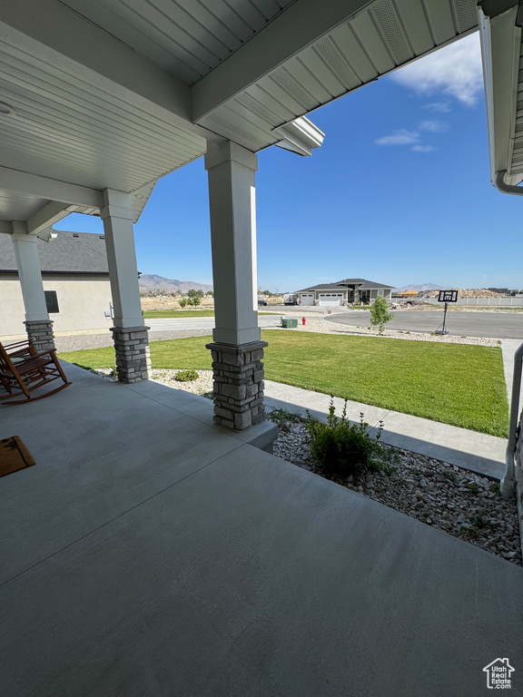 Covered porch with a lawn