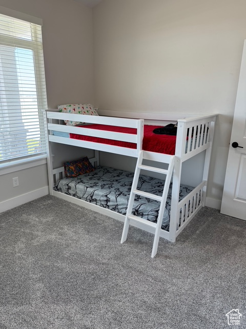 Carpeted bedroom with baseboards