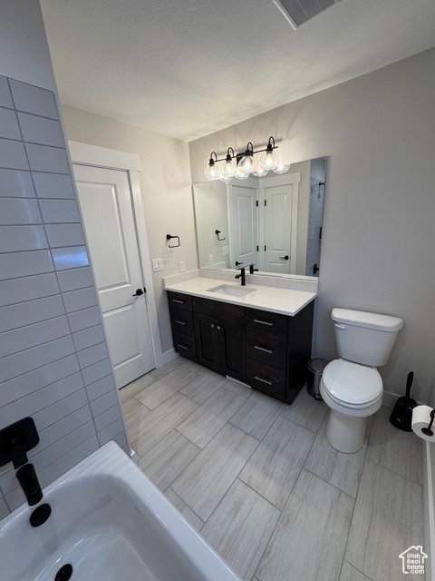Bathroom featuring vanity and toilet